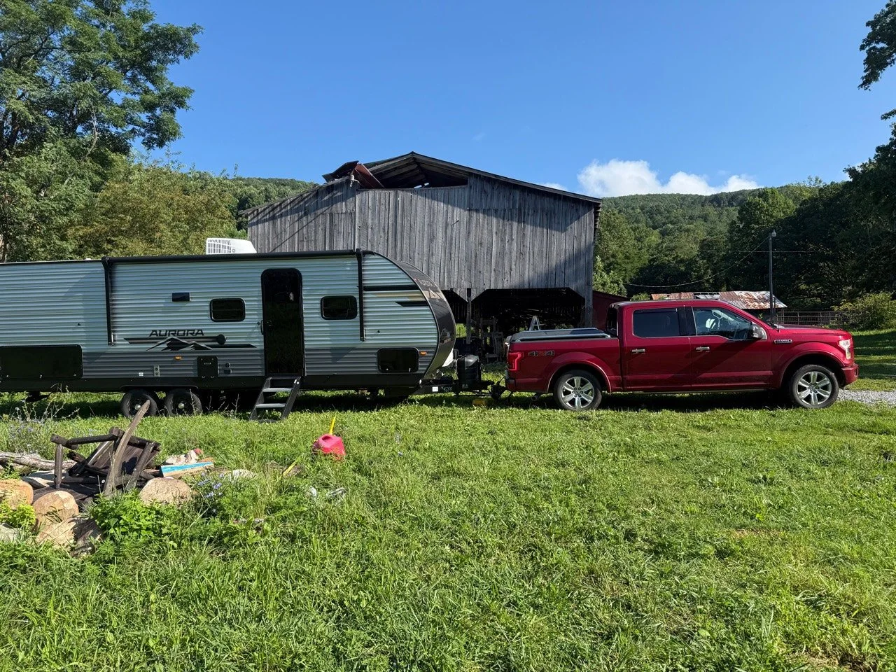 The RV Fam Adventure Ford F-150 and Aurora travel trailer hitched at the family farm.